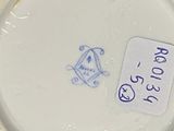 a white porcelain plate with a tag on it
