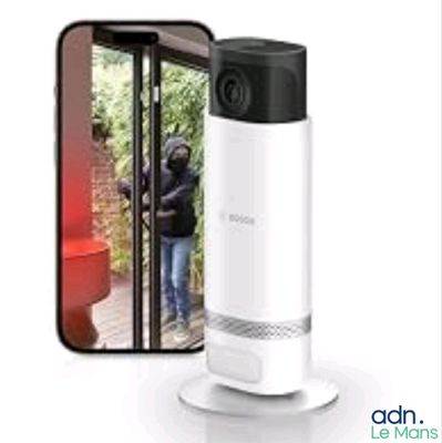 an image of a smart home security camera next to a phone