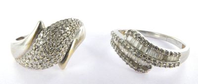 two silver rings with white diamonds on a white background