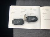 two car keys sitting on top of an open book