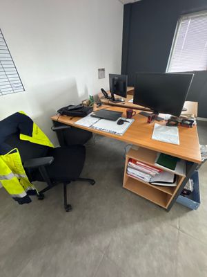 a desk with a chair and a computer on it