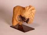 a small statue of a dog on a wooden base
