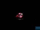 a close up of a red diamond on a black background