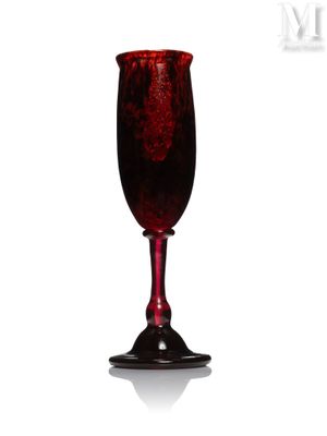 a red wine glass sitting on a white surface