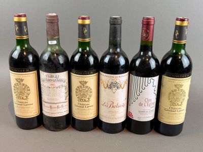 several bottles of wine are lined up on a table
