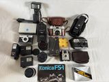 a lot of different types of cameras on a bed