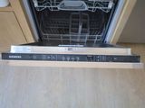 a picture of a dishwasher that is in the middle of a kitchen