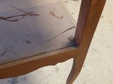 a chair that has a broken seat on it