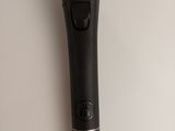 a close up of a black microphone on a white surface