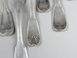 a lot of silver spoons and forks on a table