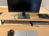 the laptop is sitting on the desk next to the monitor