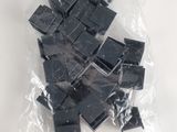many pieces of black plastic in a bag on the table