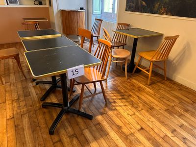 tables and chairs in a room with a painting on the wall