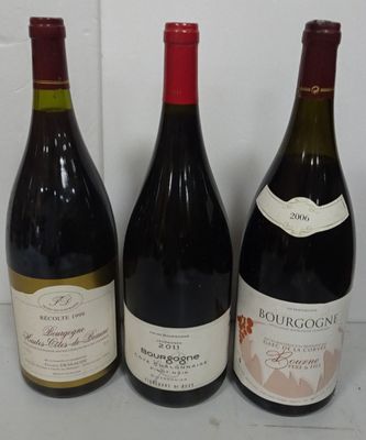 three bottles of wine are lined up on a counter top