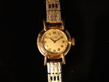 an image of a woman ' s wrist watch on a black background