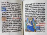 an open book with a picture of a woman in a blue dress