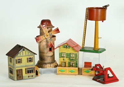 une petite collection de maisons miniatures et un moulin à vent