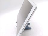 a tablet computer sitting on a stand on a table