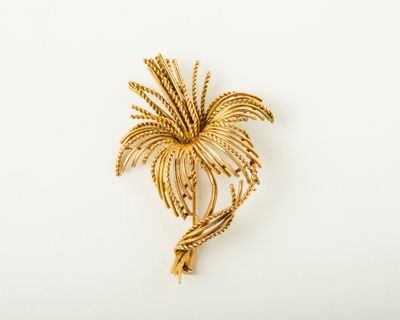 an image of a gold palm tree brooch on a white background