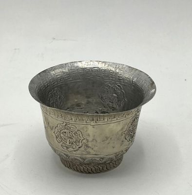 a silver bowl that is sitting on a table
