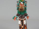 a figurine of a native american man wearing a feathered headdress