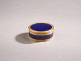 a gold and lapis ring with a blue lapis stone in the center