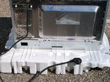 an image of a microwave sitting on top of a plastic container