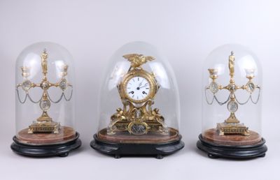 three glass domes with a clock inside of them on top of a table