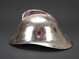 a silver helmet that is sitting on a table