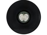 an old vinyl record on a white surface with a white background