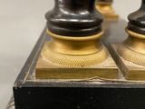 two black and gold vases sitting on top of a table