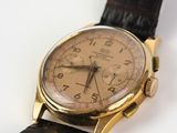 an image of a gold watch with a brown leather strap
