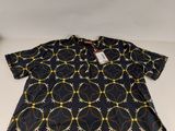 the back of a black shirt with yellow and white circles on it