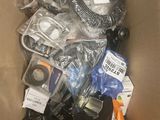a cardboard box filled with assorted electronics and other items