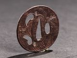 a small coin sitting on a table with a shadow on it