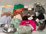 a lot of clothes that are sitting on a table