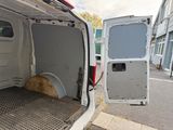 a white van with the door open on the side of the street