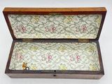 a small wooden box with a floral pattern on it