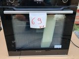 a black oven sitting on top of a cardboard box