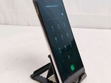 a phone that is sitting on a stand on a table