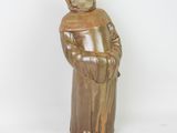 figurine of a monk in a brown robe and hat