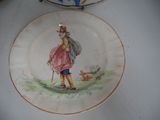a plate with a picture of a boy and a dog on it