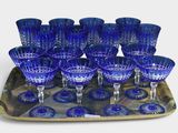 a tray with a tray of blue wine glasses on it
