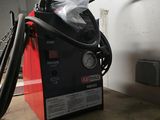 a machine that is sitting in a garage with a hose
