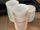 a stack of plates on a table next to a stove