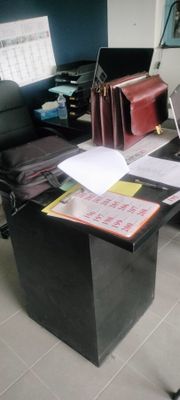 a desk with a laptop and a chair in a room