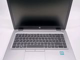 an open laptop computer sitting on top of a white table
