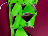 green leather boot with metal studding and a zipper on the side