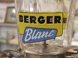 a large glass jar with a blue and yellow label on it