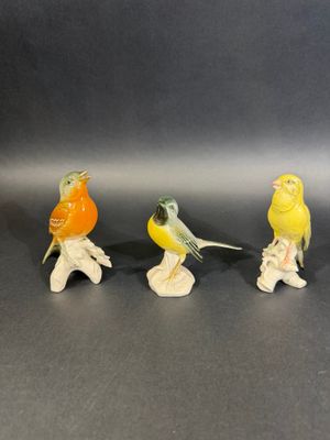 three small figurines of birds sitting on top of each other